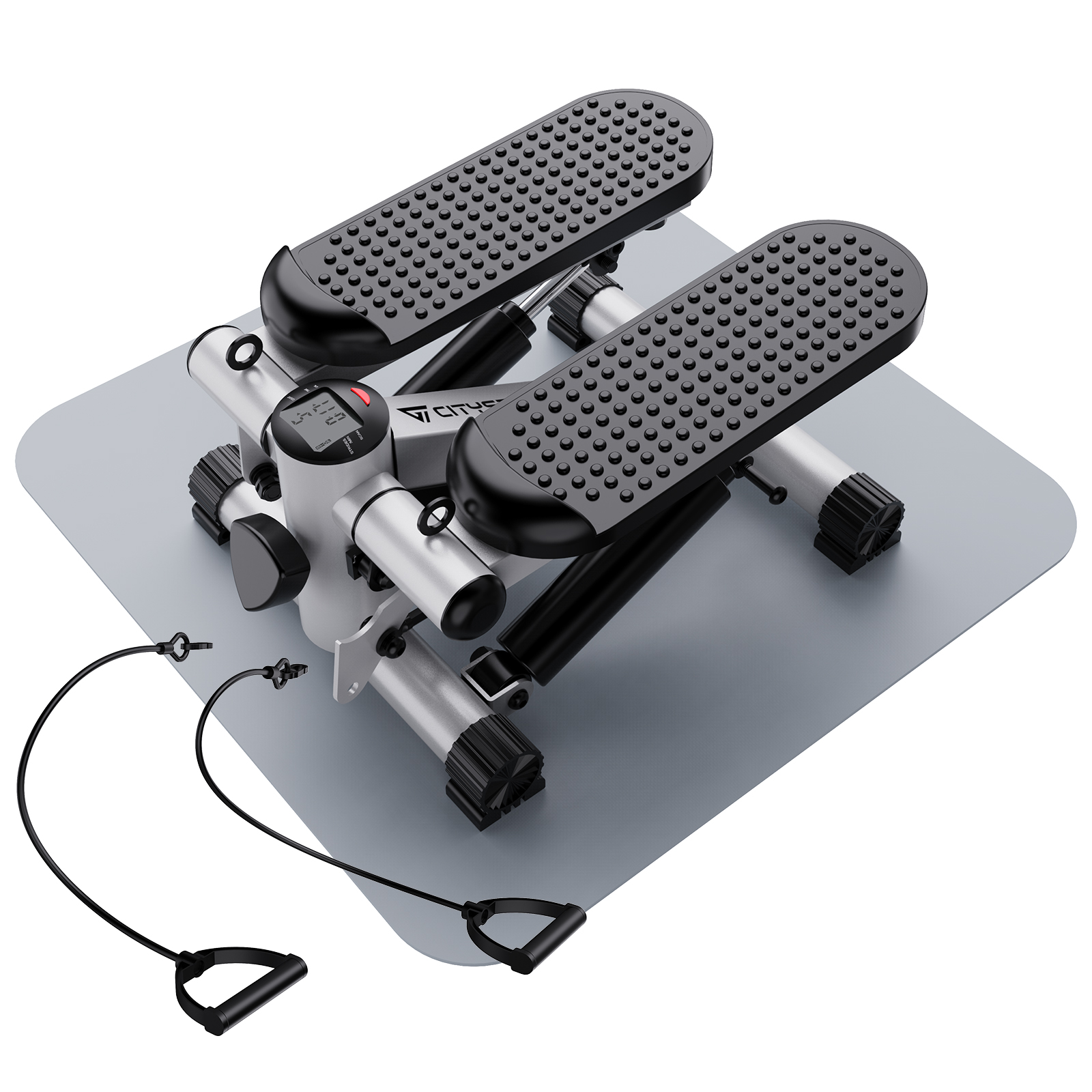 Srebrny stepper z czarnymi stopniami i uchwytami leży na szarej macie. Czarne kable z uchwytami wychodzą.