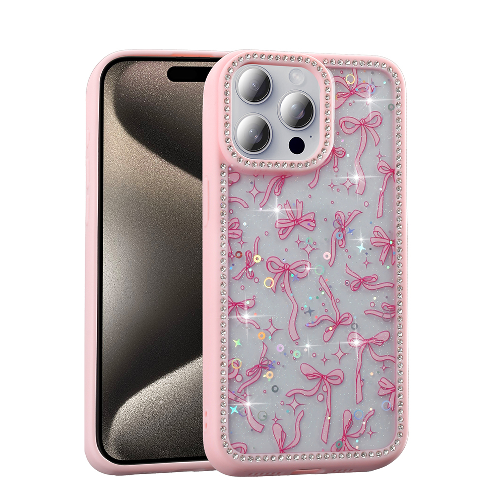 Pembe telefon kılıfı, fiyonk desenli ve ışıltılı yapay elmaslı. Siyah ekranlı bir telefon için bir kılıf.