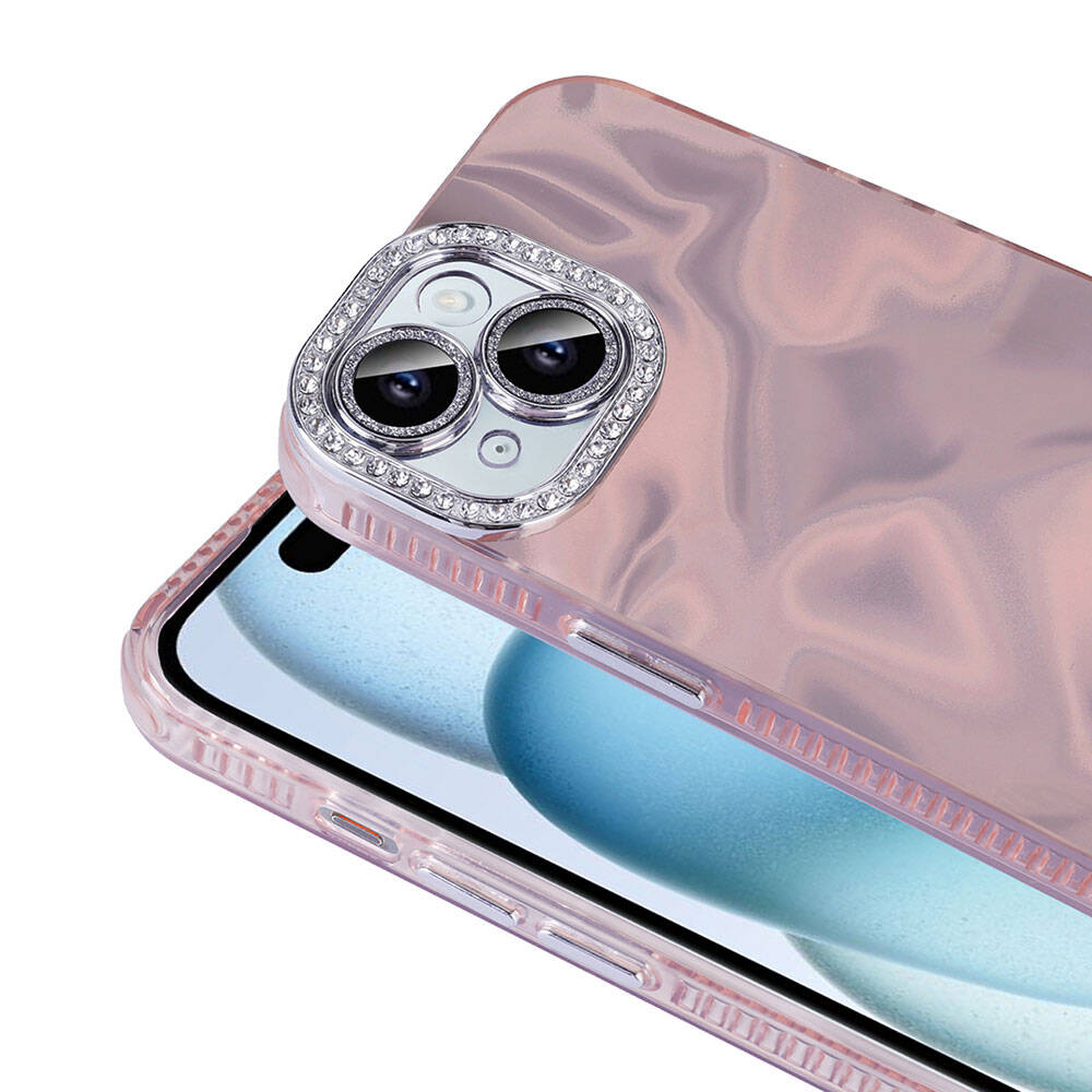 Rhinestone süslemeli bir kamera lens koruyucusuyla süslenmiş pembe bir telefon kılıfının yakın çekimi. Telefonun ekranı görünür.