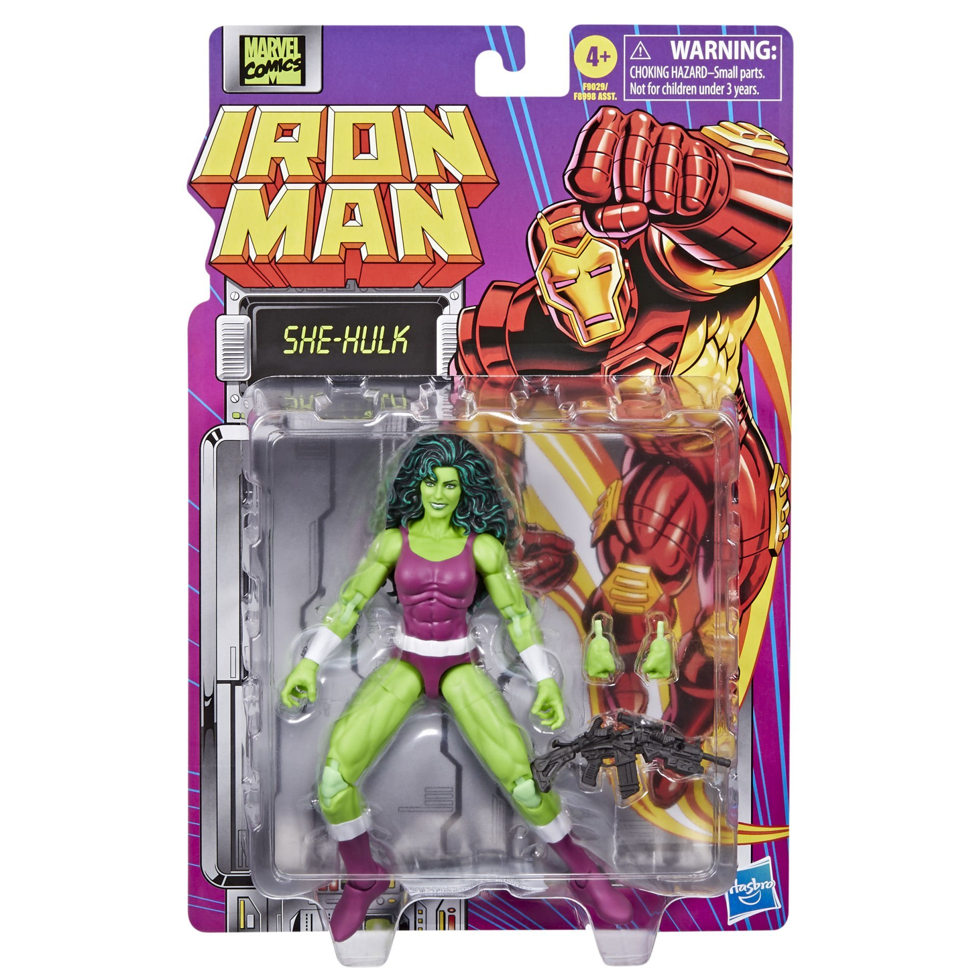 Ambalaj içinde She-Hulk aksiyon figürü. Figür yeşil ve mor renktedir. Arka plan Iron Man görüntüsüne sahip.