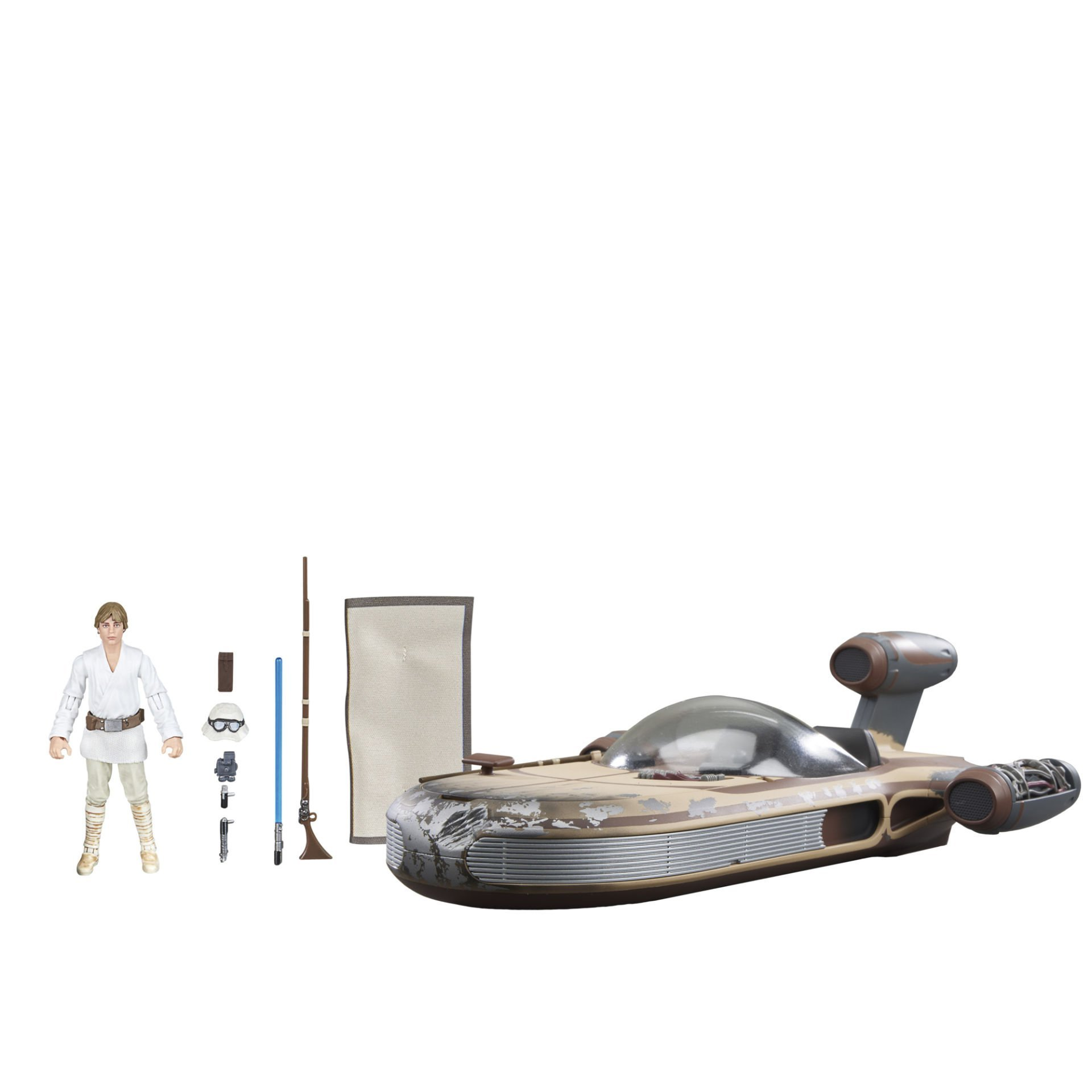 Luke Skywalker figürü ve kara hız aracı oyuncağı. Işık kılıcı ve gözlük gibi aksesuarlar içerir. Beyaz arka plan.
