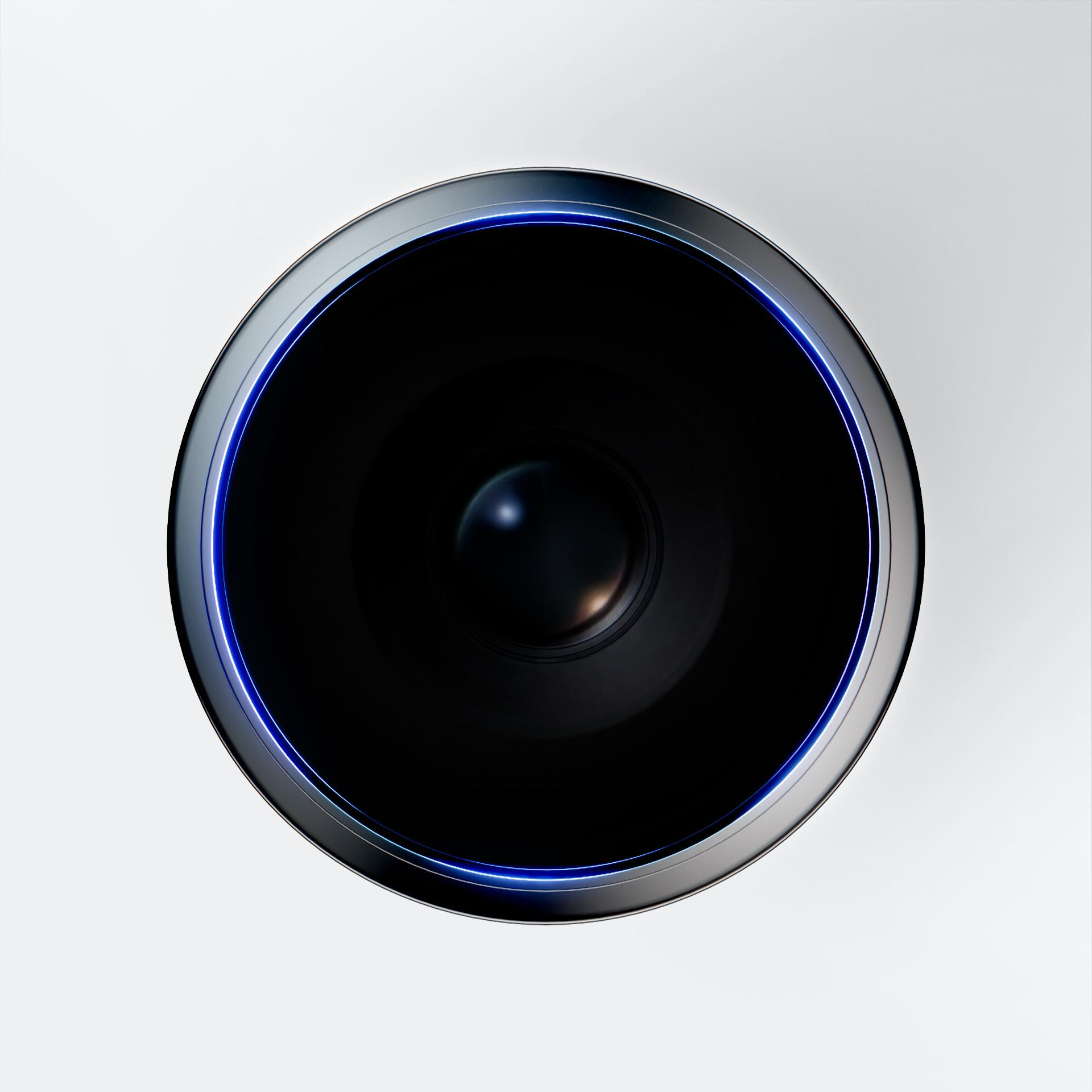 Okrągły czarny obiekt z niebieską świecącą obwódką, wyśrodkowany na białym tle. Mała soczewka widoczna w środku.