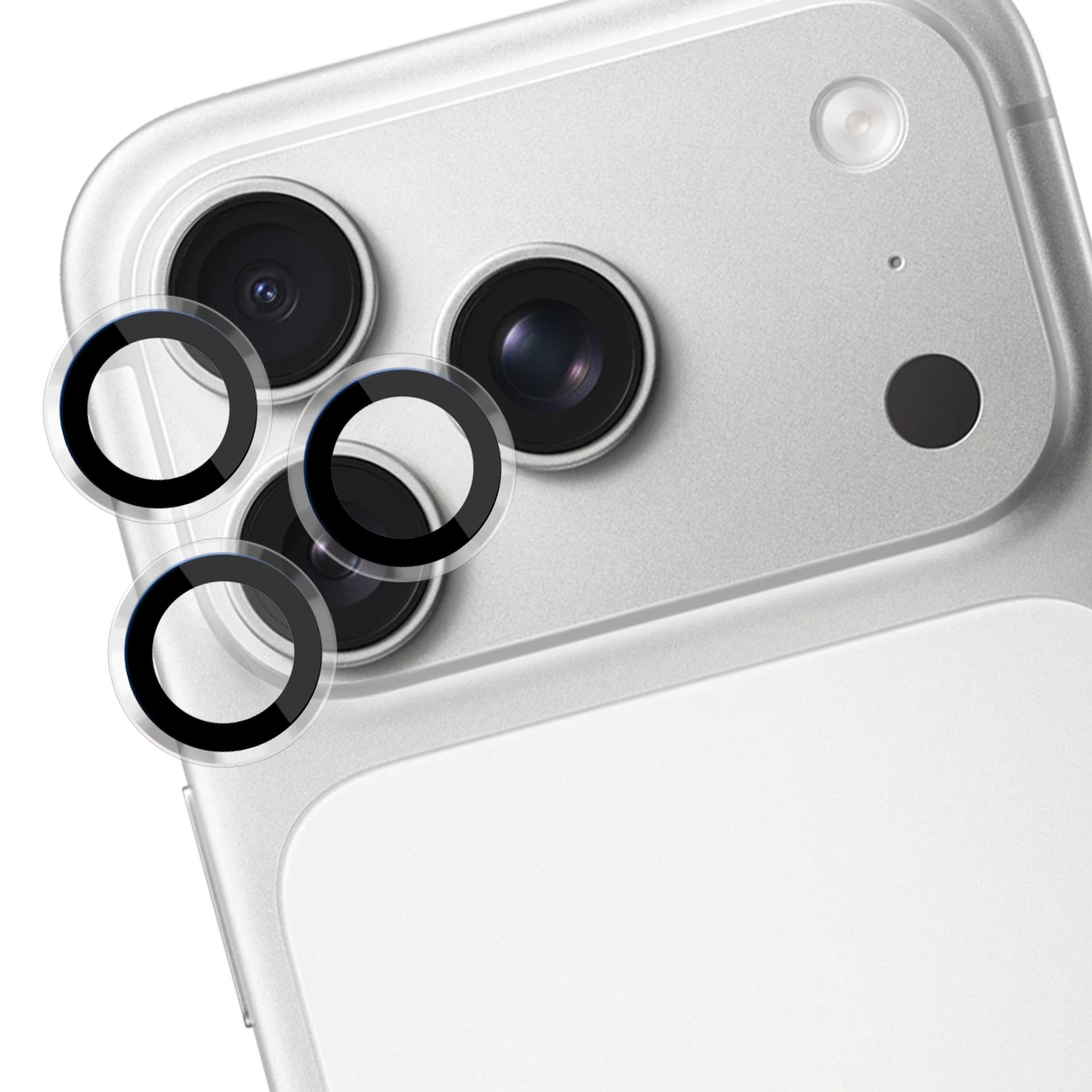 Un retro telefono argento con lenti della fotocamera. Copriobiettivo protettivi sono posizionati. Lo sfondo è bianco.