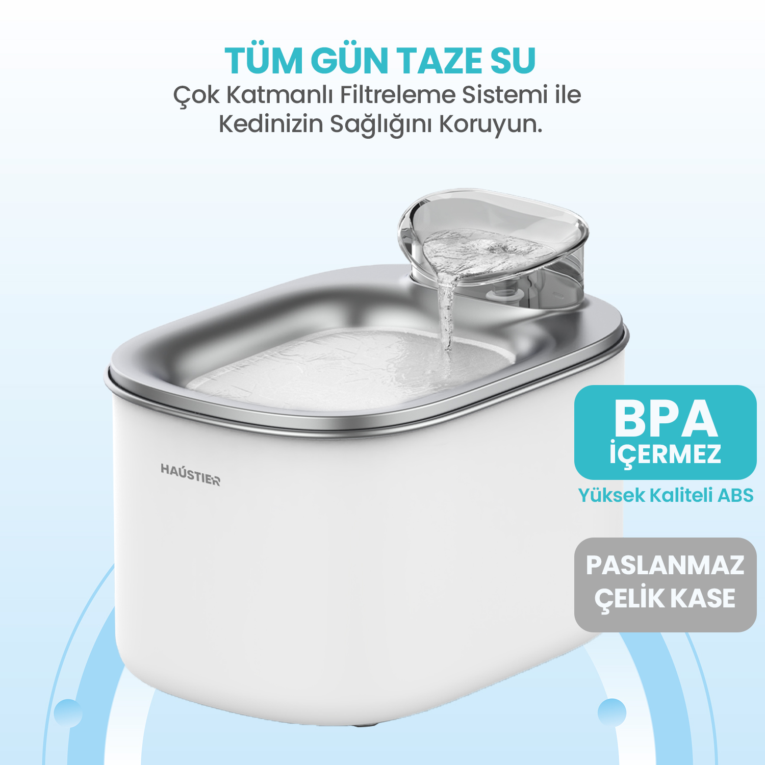 Akan su bulunan beyaz bir kedi çeşmesi. Metin: 'Tüm gün taze su' ve 'paslanmaz çelik kase'.