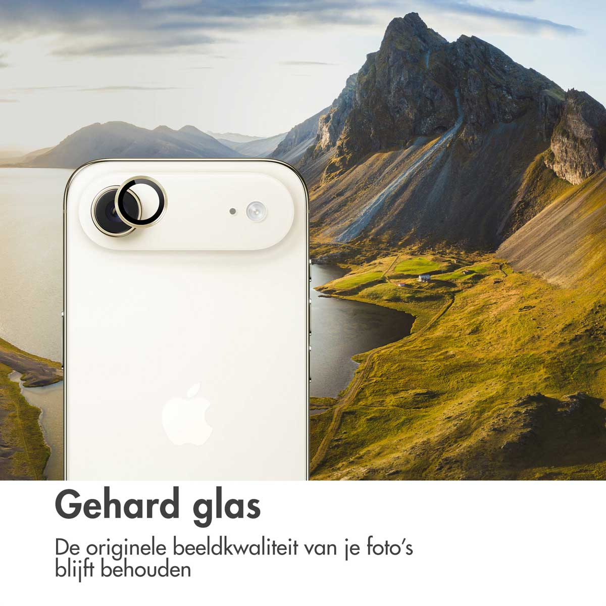 A white phone with camera lenses is in front of a landscape with mountains, a lake, and green fields.