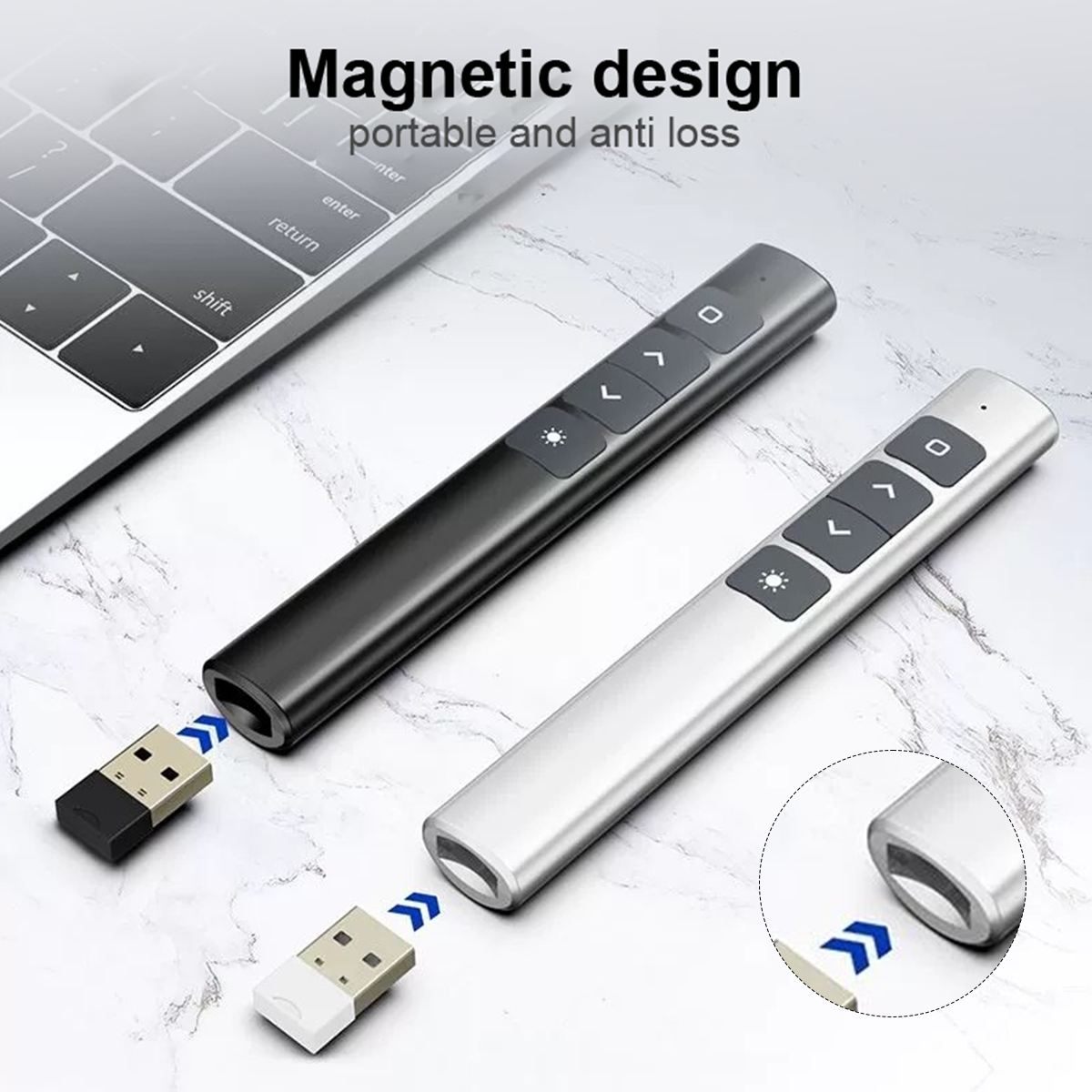 Zwei Präsentations-Clicker, schwarz und silber, mit USB-Empfängern. Eine Laptop-Tastatur befindet sich im Hintergrund, auf einer marmorähnlichen Oberfläche.