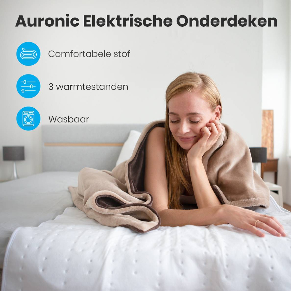 Femme sur lit enveloppée dans une couverture beige. Texte dit Auronic Elektrische Onderdeken. Icônes indiquent tissu, 3 réglages et lavable.
