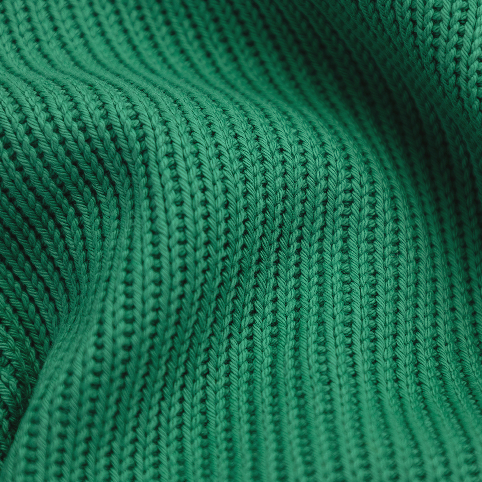 Gros plan sur un tissu en maille verte texturé avec des côtes verticales visibles et des ondulations subtiles.