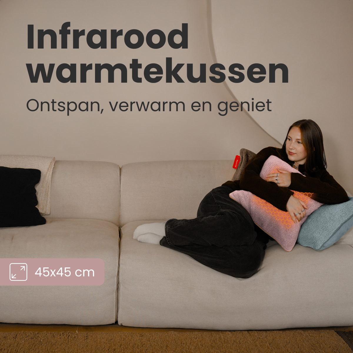 A woman lies on a sofa, holding a pink infrared heating cushion. Text on top says 'Infrared warmtekussen'.
