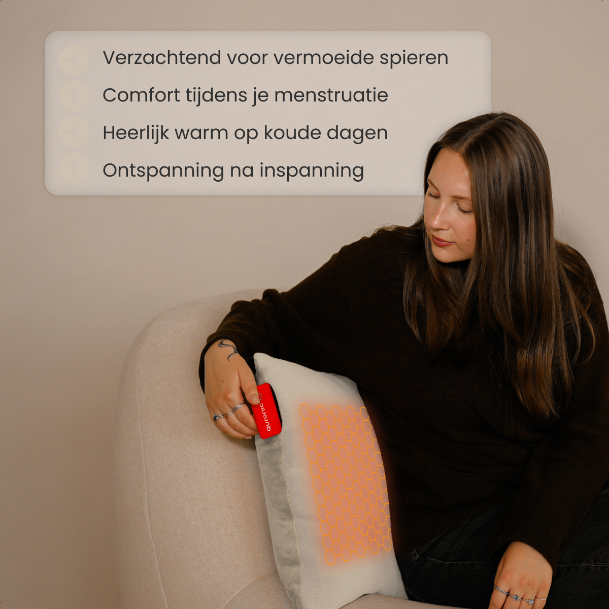 A woman sits on a couch, holding a pillow with orange cells. Text above lists benefits, like relaxation and warmth. Product is Quronic.