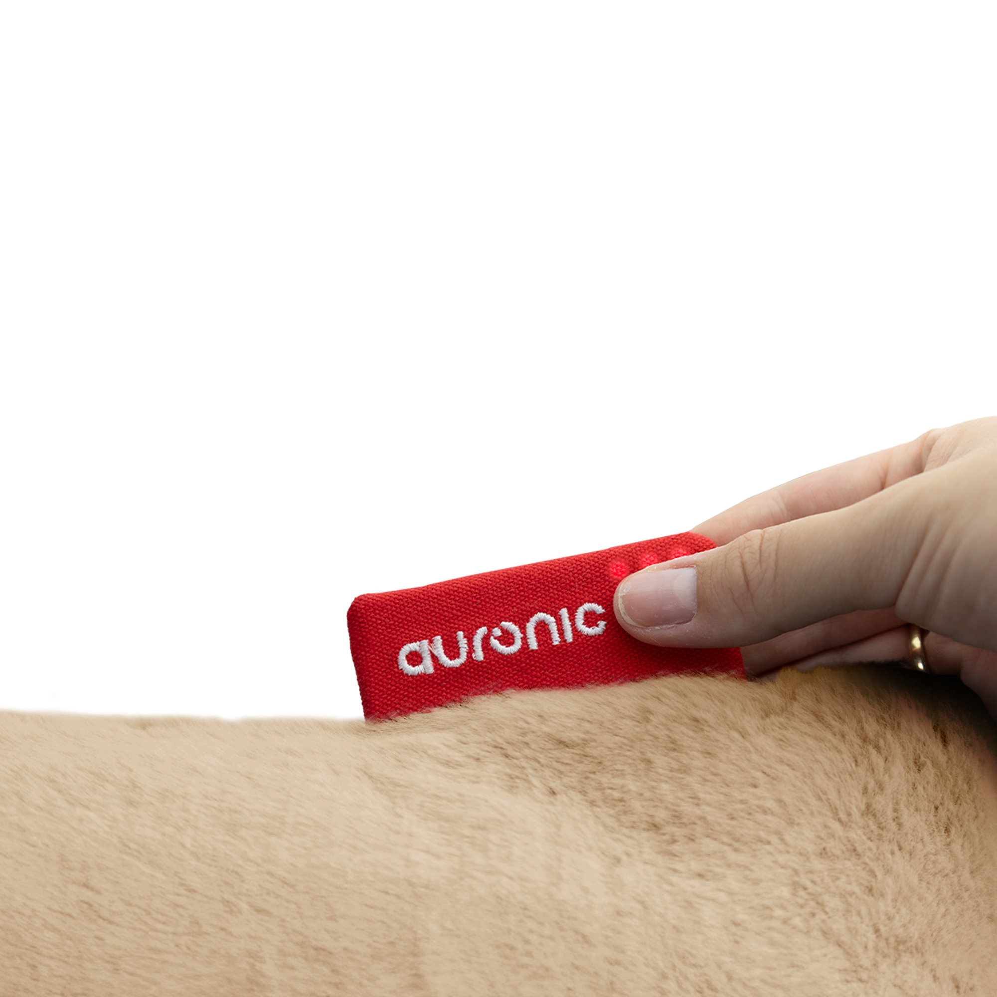 A hand holding a red tag, with the word 'auronic' on it, over light brown fur. White background.