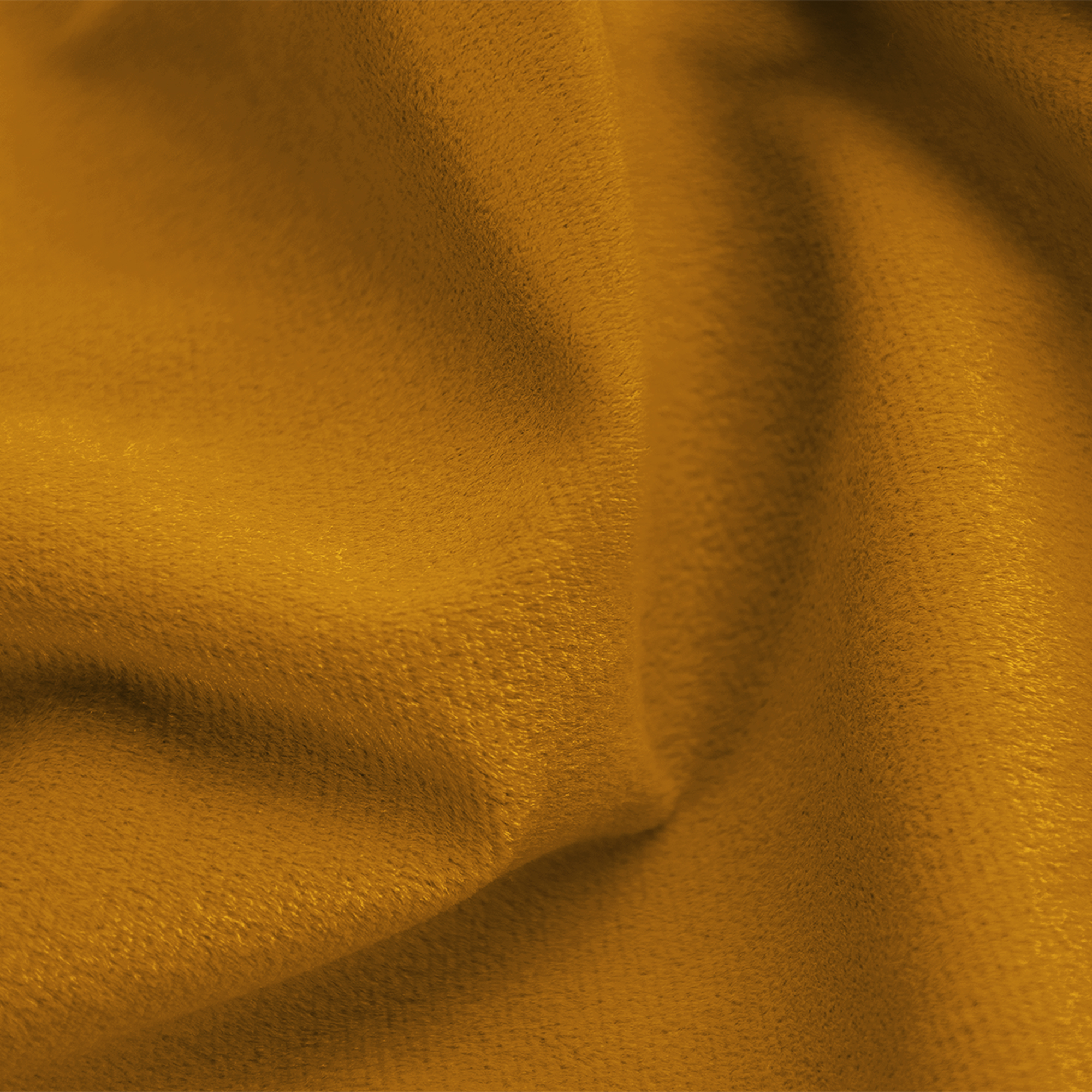 Gros plan sur un tissu de couleur moutarde avec une surface douce et texturée, des plis doux et des ombres.