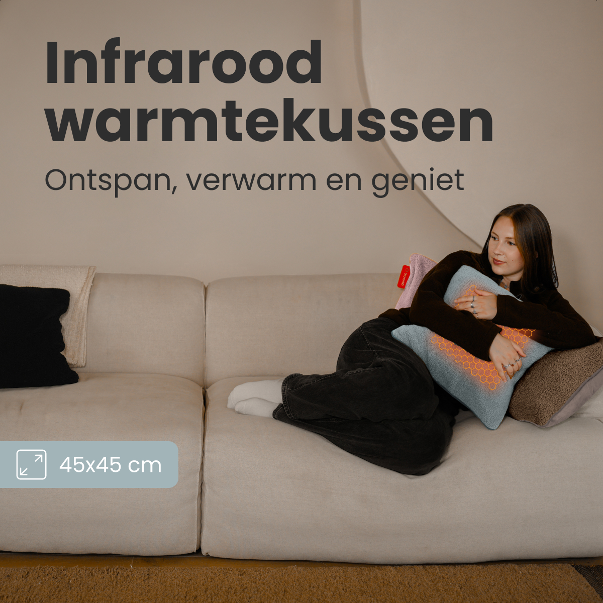 A woman reclines on a couch, holding a blue heating pad. Text above reads 'Infrared warmth cushion.' A size indicator is visible.
