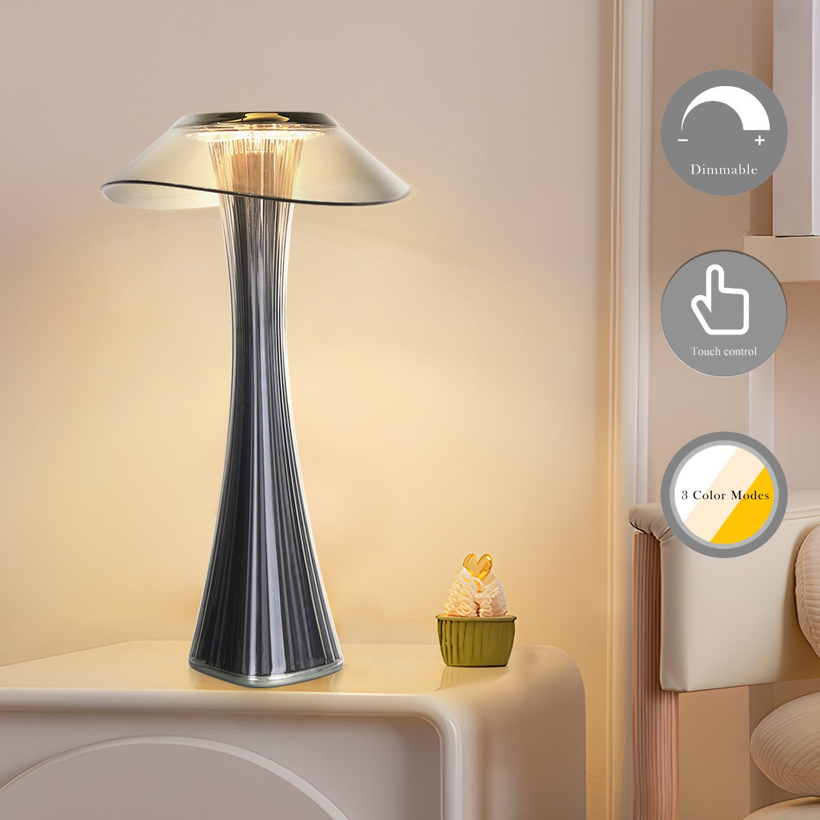 Una lampada elegante con paralume in vetro, su un tavolo con un cupcake. Dimmerabile, controllo touch e 3 modalità colore.