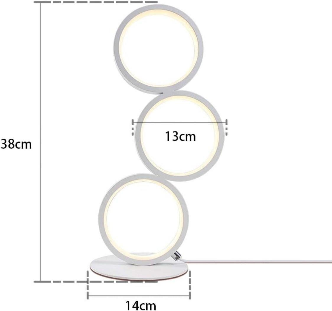Una moderna lampada a LED bianca con tre pannelli luminosi circolari, poggiata su una base rotonda. Sono indicate le misure di 38 cm di altezza e 14 cm di larghezza della base.