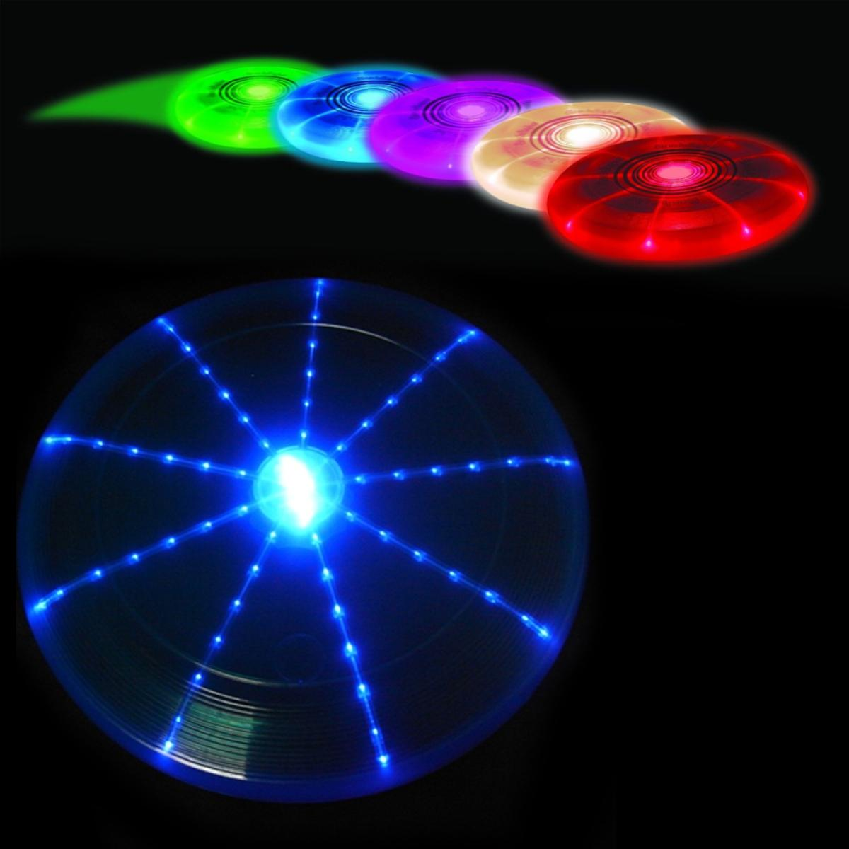 Verschillende gloeiende frisbees op een rij. Eén licht op en toont een centraal punt en uitstralende lijnen. Kleuren zijn groen, blauw, paars en rood.