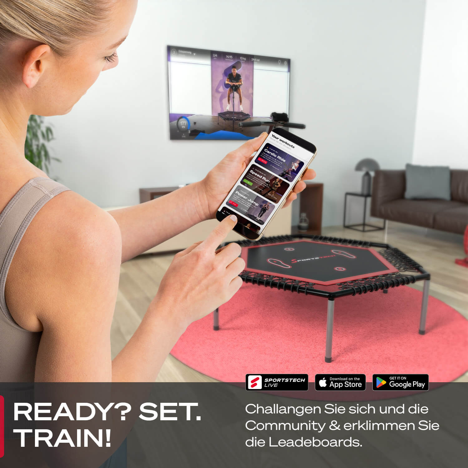 Frau benutzt Smartphone mit Workout-App neben Trampolin. Ein Fernseher zeigt eine Person beim Springen. Bereit? Los geht's. Trainieren!