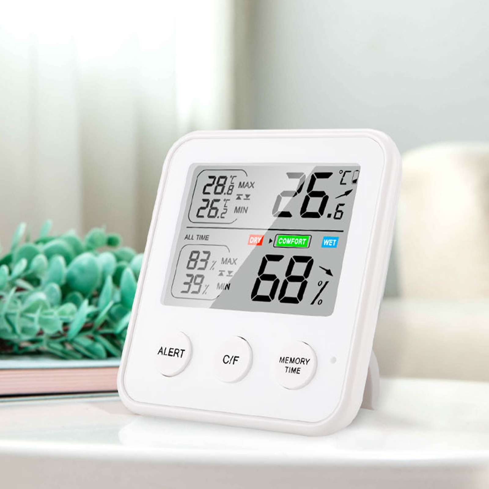 Ein weißes digitales Thermometer, das Temperatur und Luftfeuchtigkeit anzeigt. Es zeigt 26,6 °C, 68 % Luftfeuchtigkeit und Komfort an.