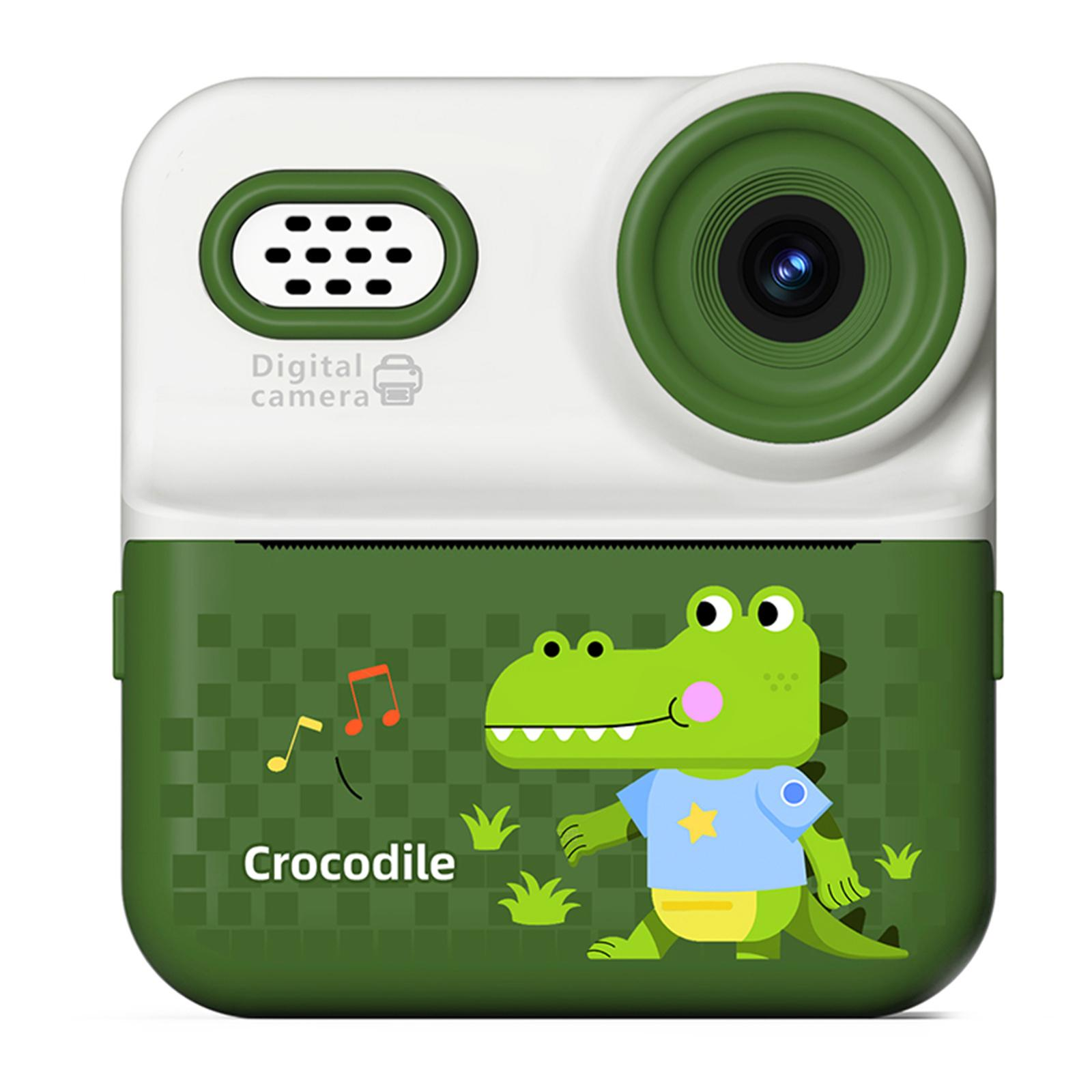 Eine Digitalkamera mit einem Cartoon-Krokodil-Design. Grün und Weiß, Krokodil trägt blaues Hemd. Noten.