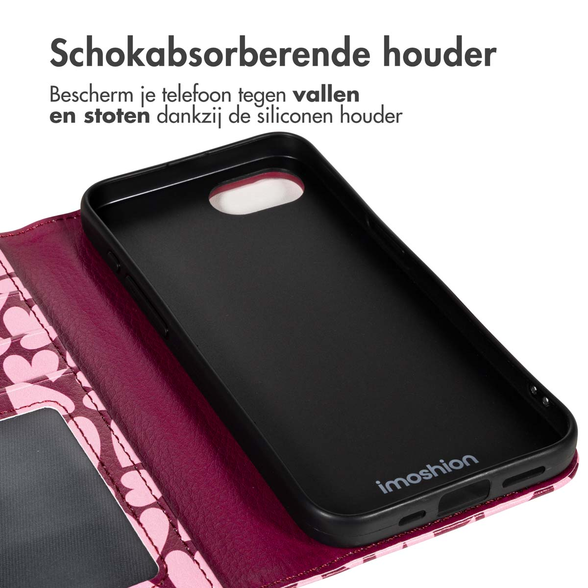 Zwarte telefoonhoes open, met het interieur zichtbaar. Roze hartpatroon op de cover, tekst 'Schokabsorberende houder' bovenaan.