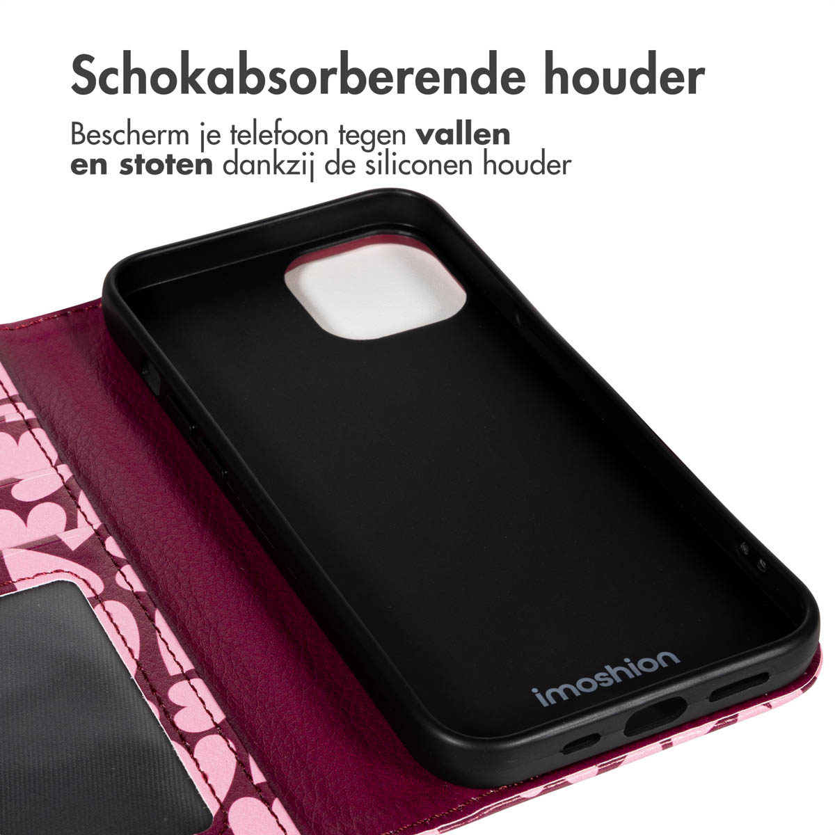 Een zwarte telefoonhoes met een roze hartpatroon aan de binnenkant is open. De tekst luidt: 'Schokabsorberende houder. Bescherm je telefoon'.
