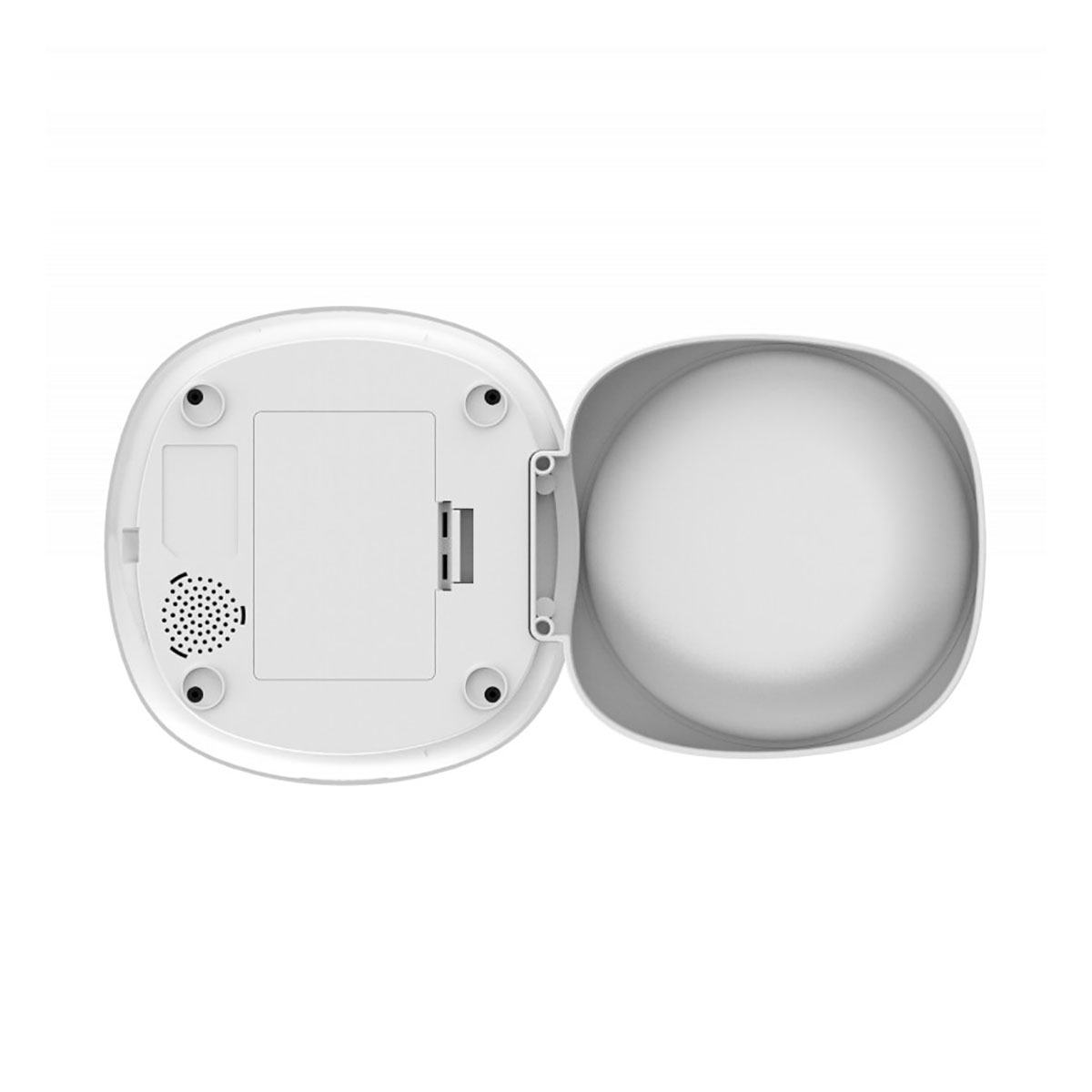 Widok z góry na białe urządzenie z otwartą pokrywą. Ma głośnik i prostokątną komorę. Widoczne są cztery czarne nóżki.