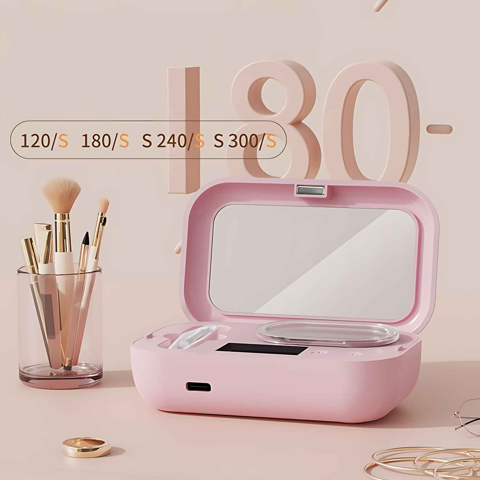 Ein rosa Make-up-Organizer mit Spiegel, Pinseln und einem Ring. Oben sind Zahlen sichtbar. Der Hintergrund ist schlicht.