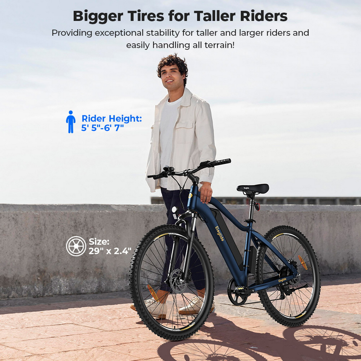 Mężczyzna z niebieskim rowerem Eleglide. Tekst: 'Większe opony dla wyższych rowerzystów'. Informacje o wzroście rowerzysty i rozmiarze opon.