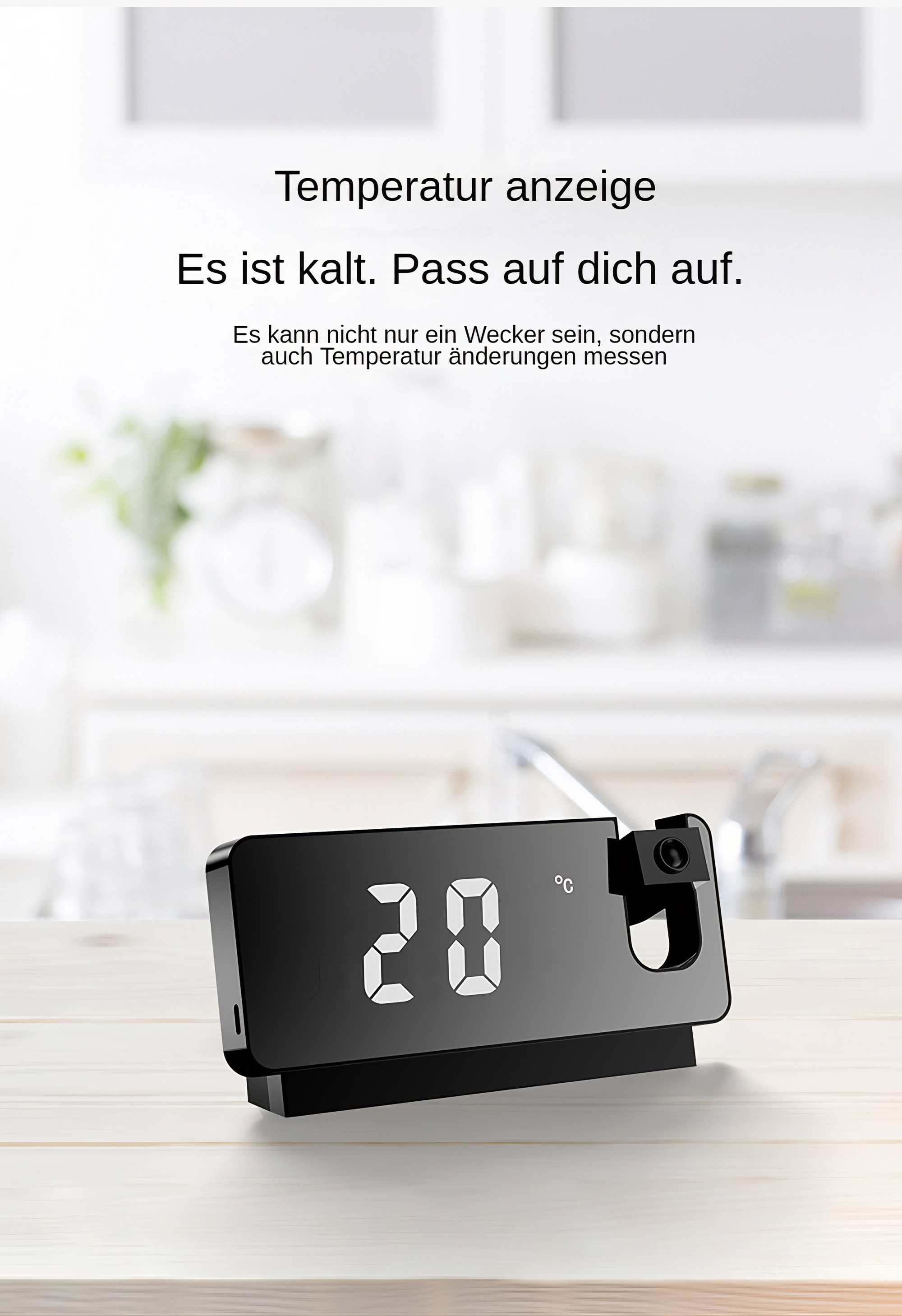 Ein schwarzes Digitalthermometer zeigt 20 Grad Celsius an. Der Text darüber lautet: 'Es ist kalt. Pass auf dich auf.'