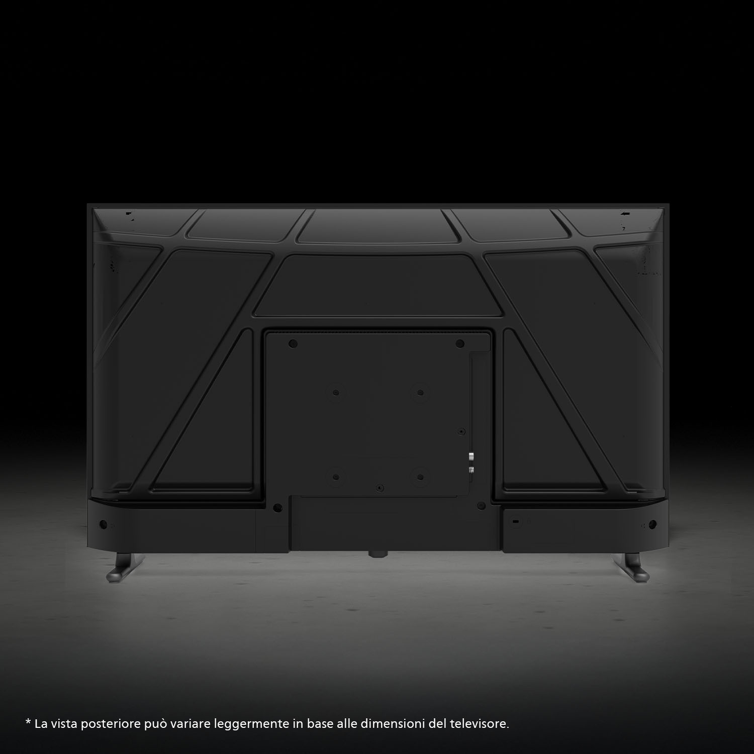 Tył czarnego telewizora na szarej powierzchni. Tył ma geometryczny wzór i centralny panel z portami.