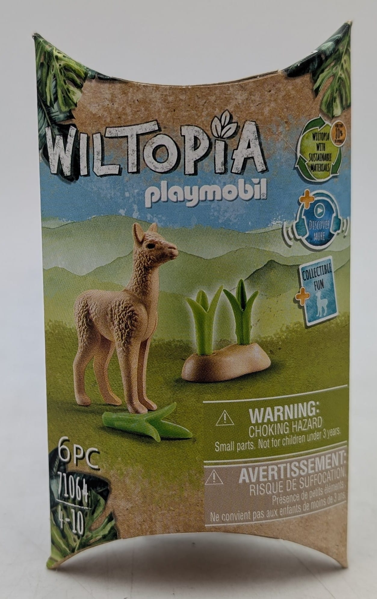Zestaw Playmobil z lamą, zieloną trawą i innymi elementami. Zawiera ostrzeżenie o małych częściach.