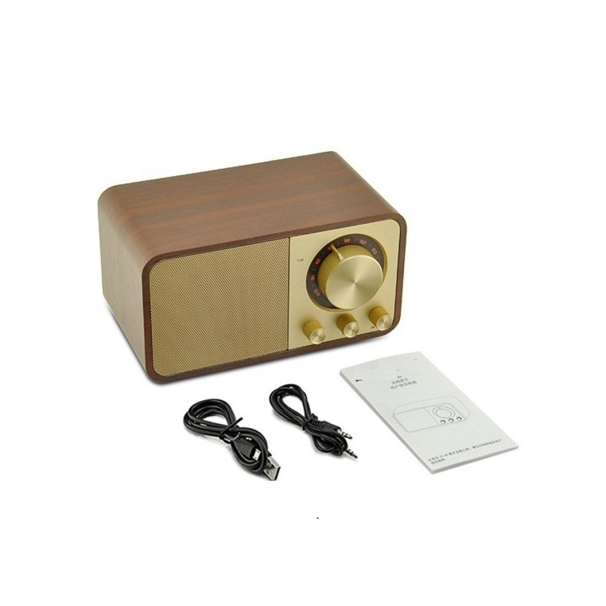 Ein Vintage-Radio mit Holzoberteil, goldener Front. Kabel und eine Anleitung liegen daneben auf weißem Hintergrund.