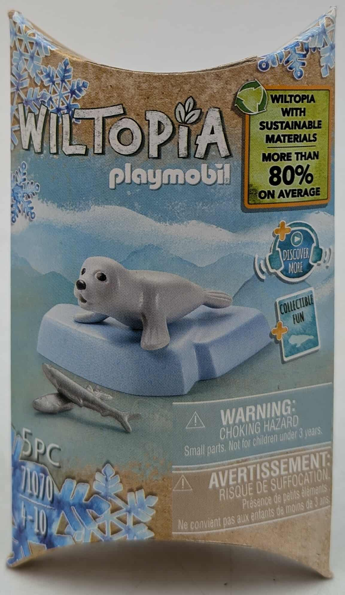 Box with a toy seal on an ice floe. The box is for Playmobil's Wiltopia series, with sustainability messaging.