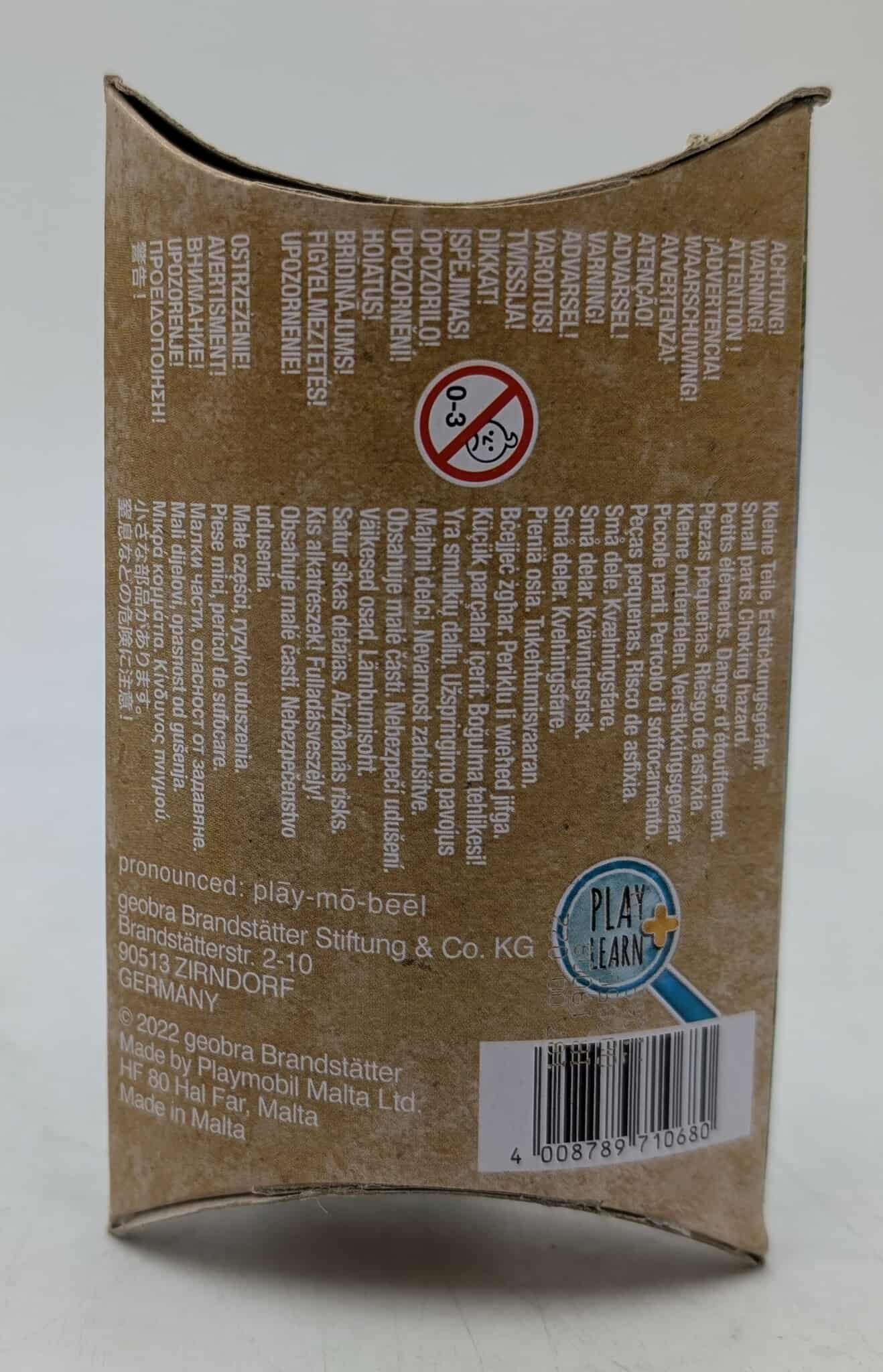Karton mit Warnhinweisen in mehreren Sprachen, Altersbereich 0-3 und Barcode.