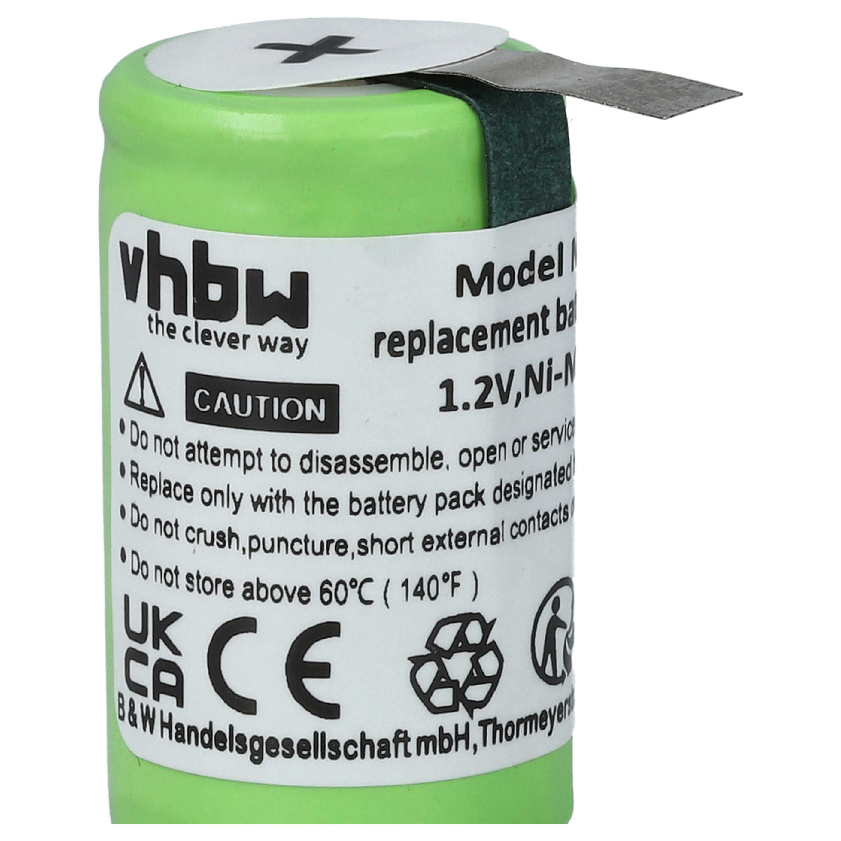 Grüne Batterie mit Etikett. Text enthält Warnhinweise und Spezifikationen wie 1,2 V Ni-M. Ein Metallstreifen ragt aus der Oberseite.