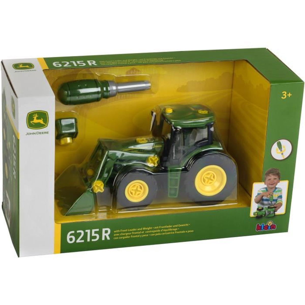 Un trattore giocattolo John Deere verde in una scatola con un cacciavite e accessori. Un ragazzo è raffigurato sulla scatola.