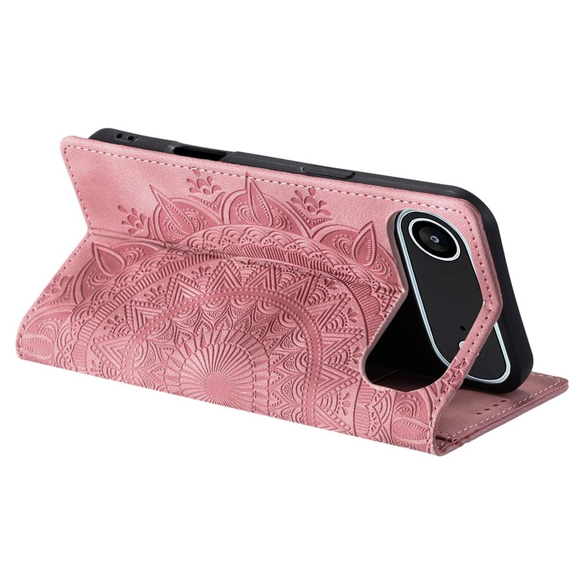 Eine rosa Handyhülle mit Mandalamuster. Das Telefon ist schwarz und die Hülle ist offen. Es liegt auf einer weißen Oberfläche.