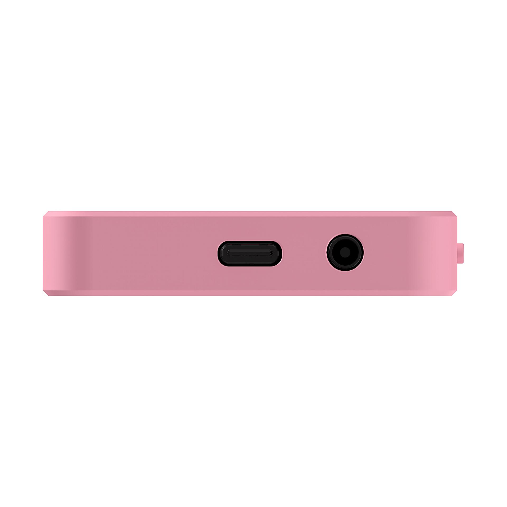 Różowe prostokątne urządzenie. Posiada port USB, gniazdo słuchawkowe i mały przycisk.