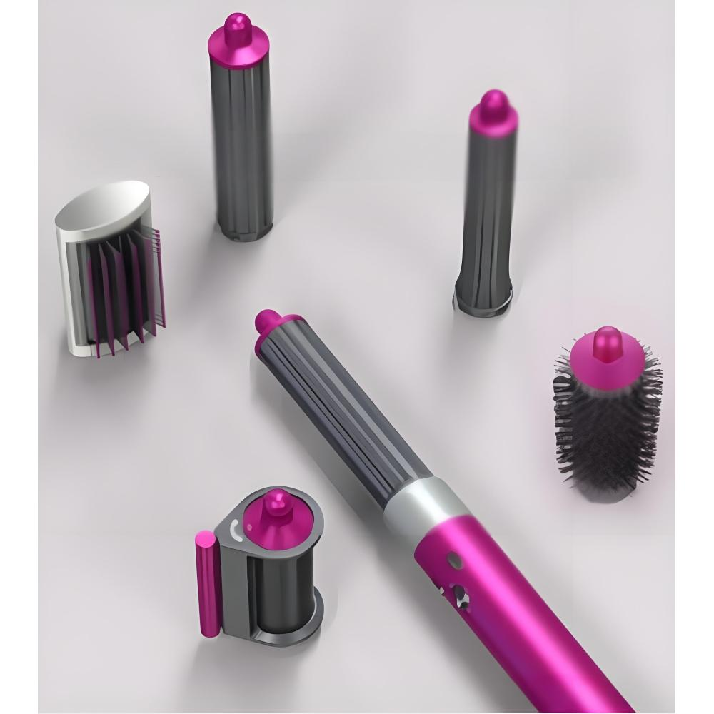 Ein pink-graues Haarstyling-Werkzeug mit verschiedenen Aufsätzen, darunter Lockenwickler und Bürsten, auf einer weißen Oberfläche angeordnet.