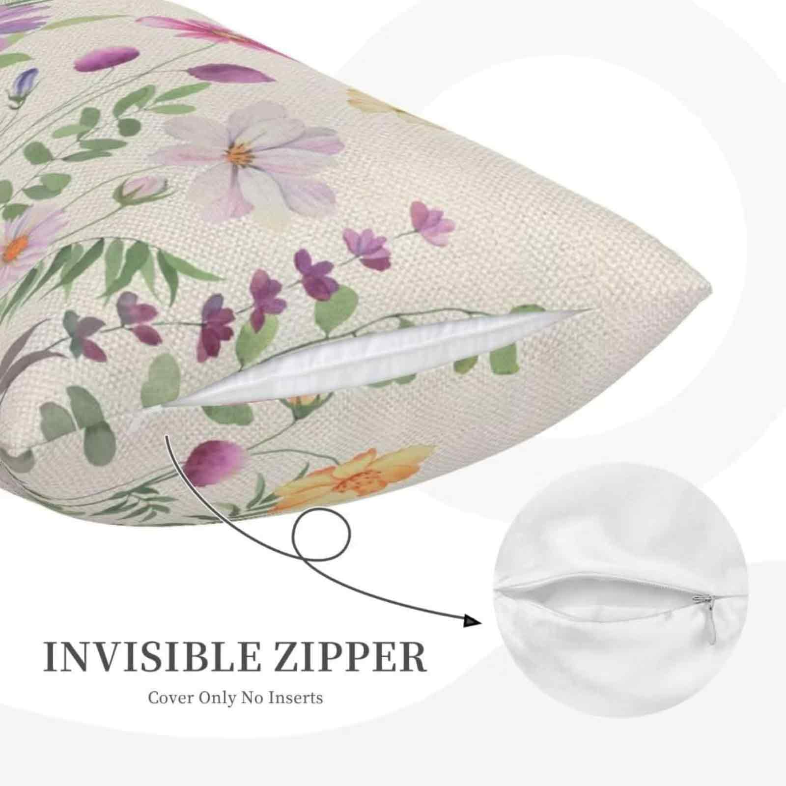 Kissen mit Blumendruck, weißem Hintergrund und unsichtbarem Reißverschluss. Blumen sind rosa, lila und gelb.