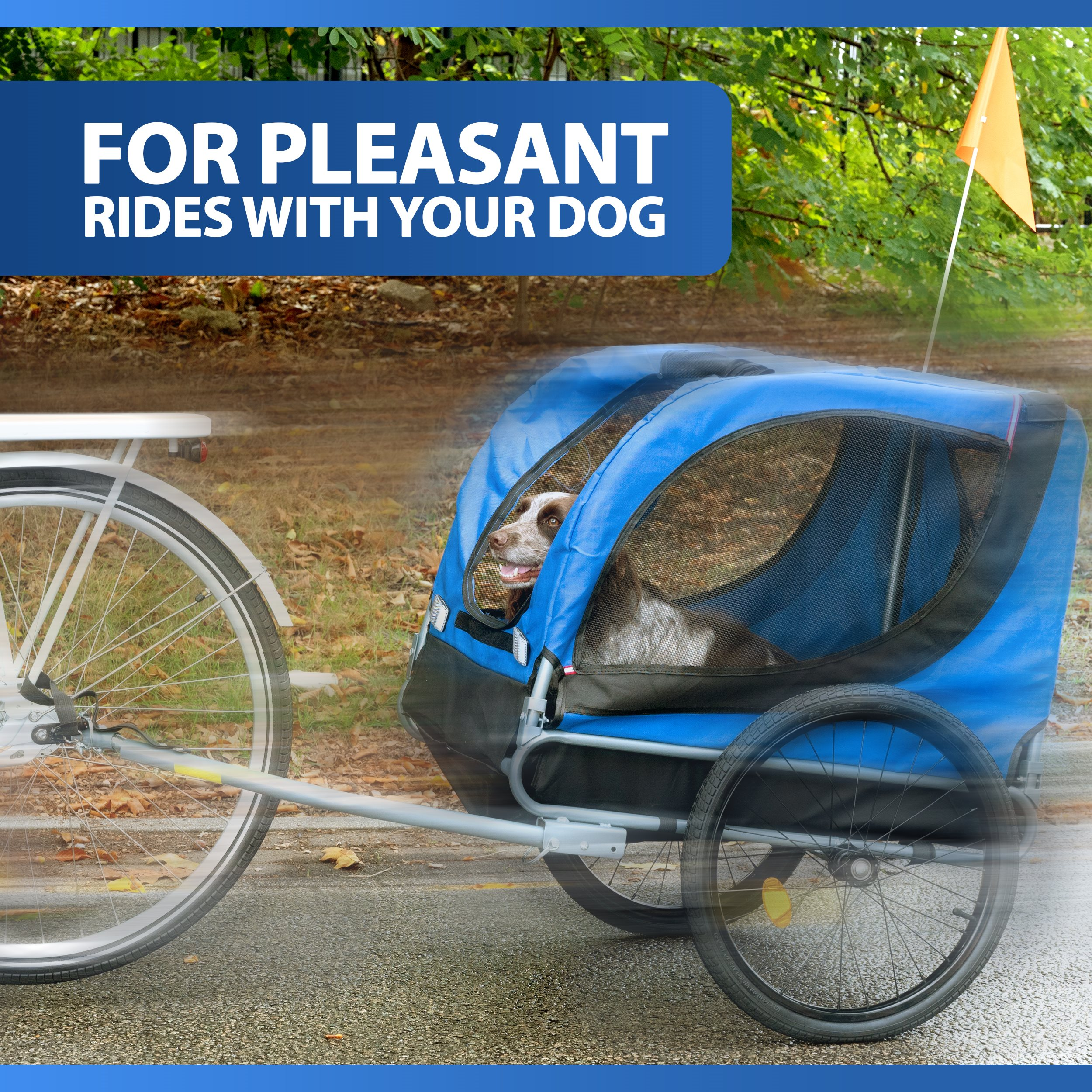 A dog in a blue trailer attached to a bike. An orange flag is on the side. The background shows trees.