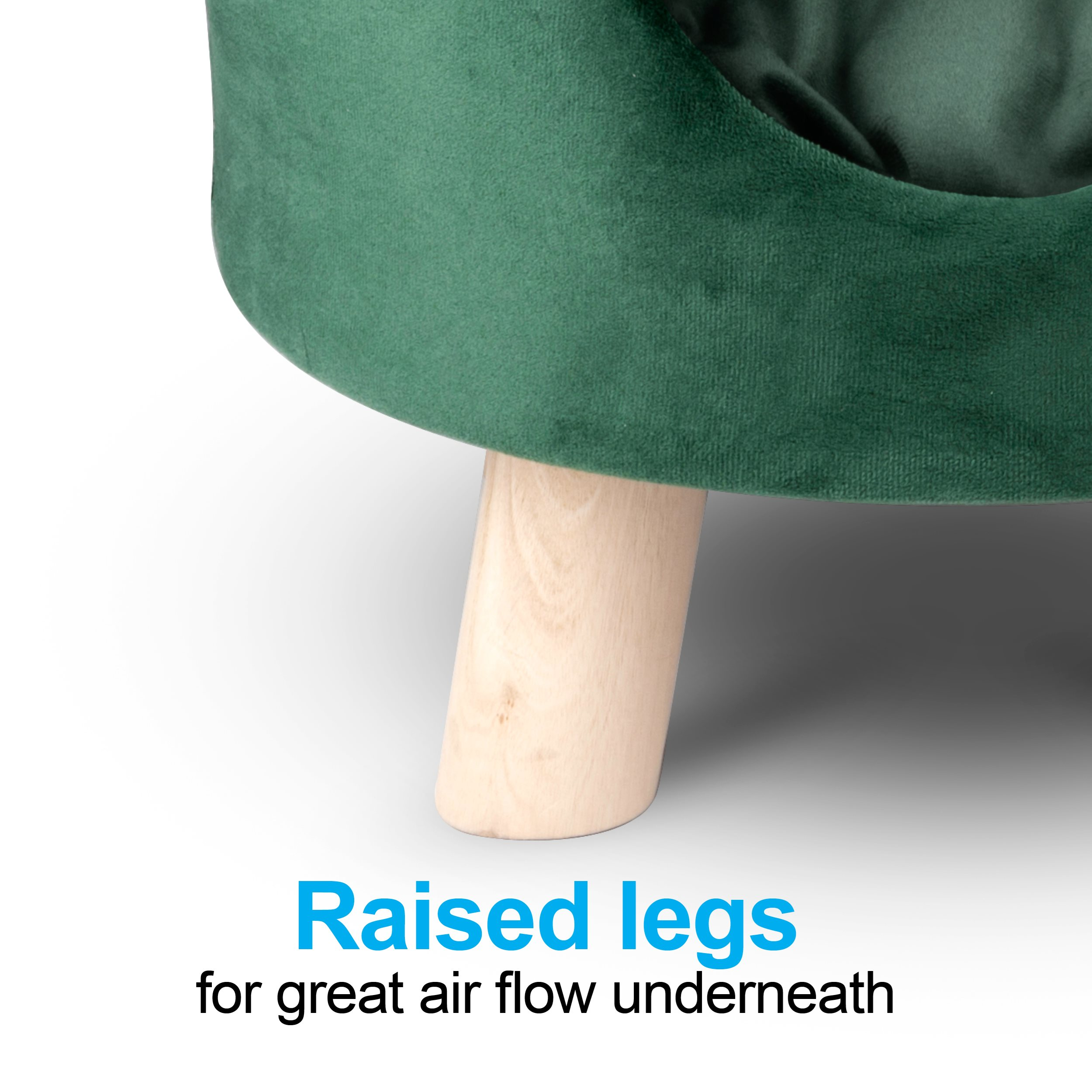 Close-up of a green velvet chair with wooden legs. Text: Raised legs for great air flow underneath.