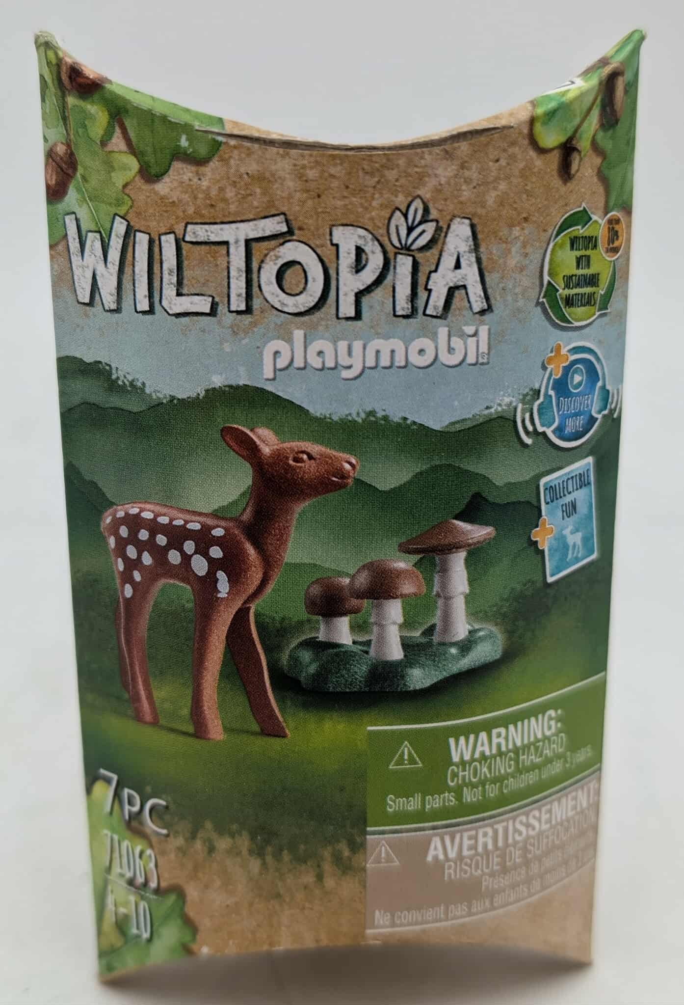 Box shows a deer toy with mushrooms and the text 'Wiltopia Playmobil'. It warns about choking hazards due to small parts.