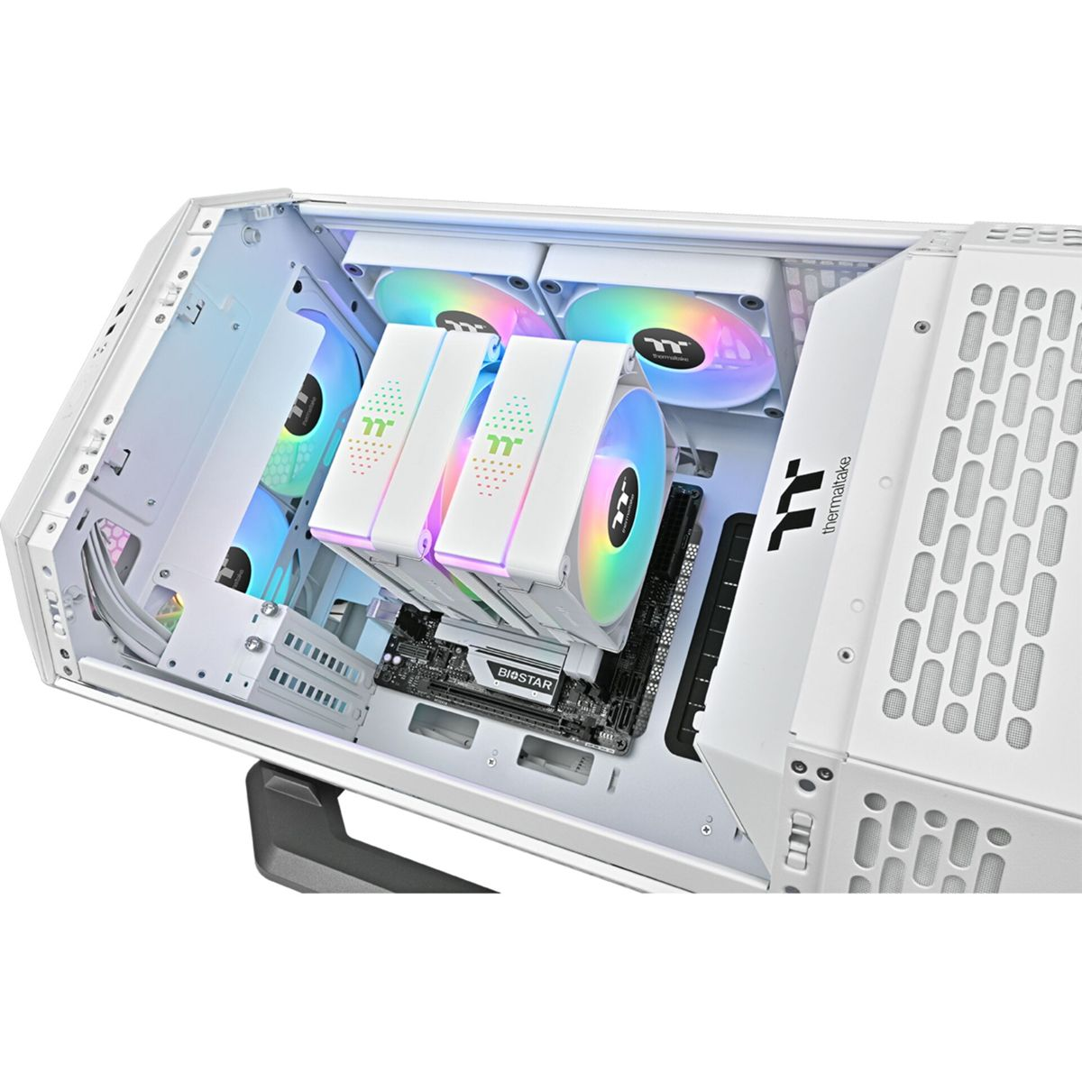 Inside a white computer case, components are visible: fans, a motherboard, and a cooler. The fans display colorful lights. The case is open.