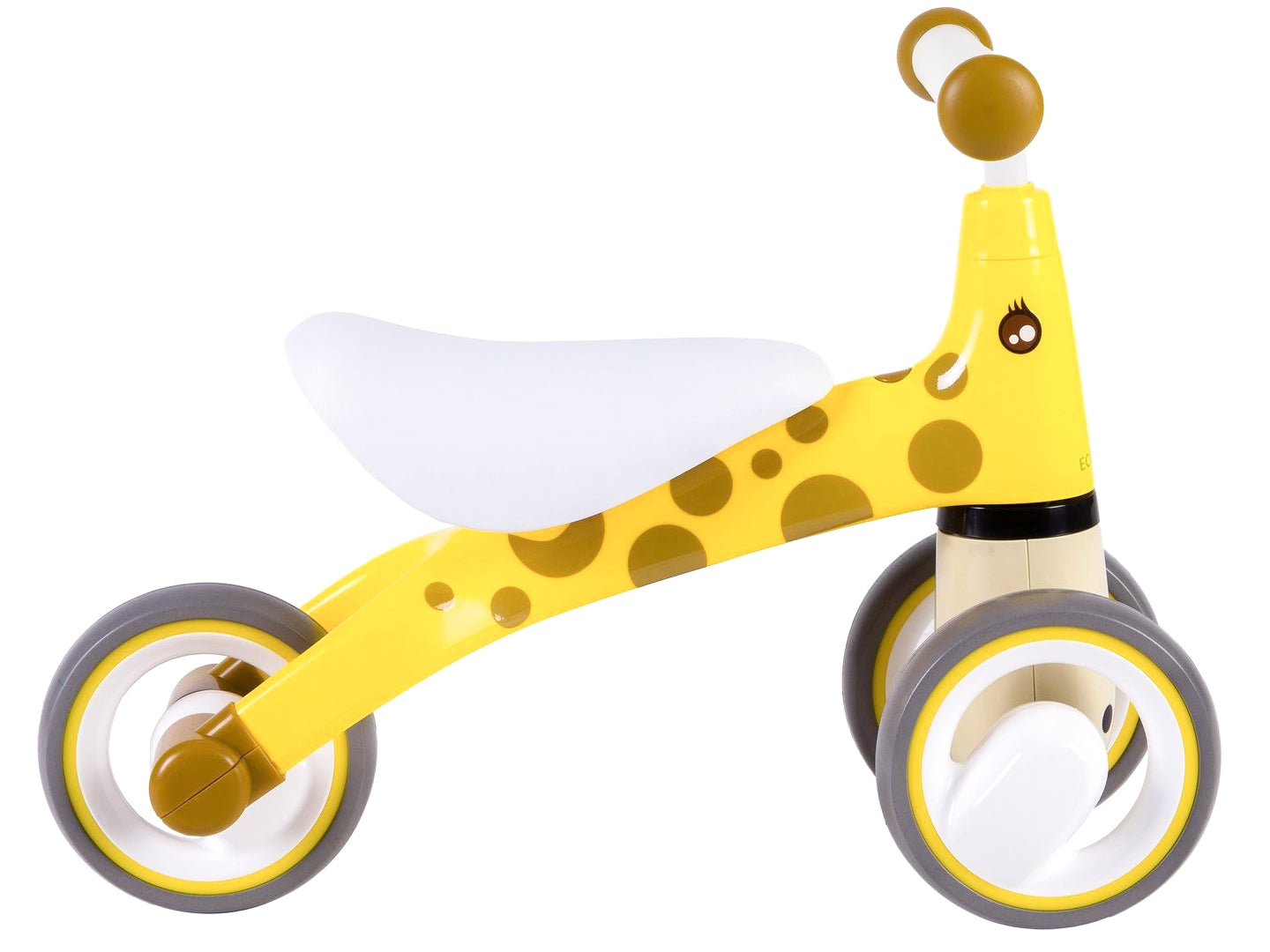 Una bicicleta de equilibrio amarilla con diseño de jirafa, asiento blanco, manchas marrones y ruedas grises y amarillas, sobre fondo blanco.