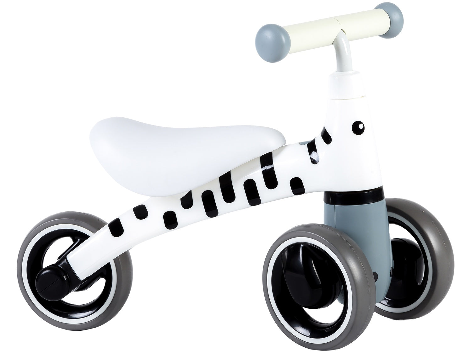 Una bici senza pedali bianca e grigia a tema zebra. Ha sella, manubrio e telaio bianchi con macchie nere. Ruote grigie.
