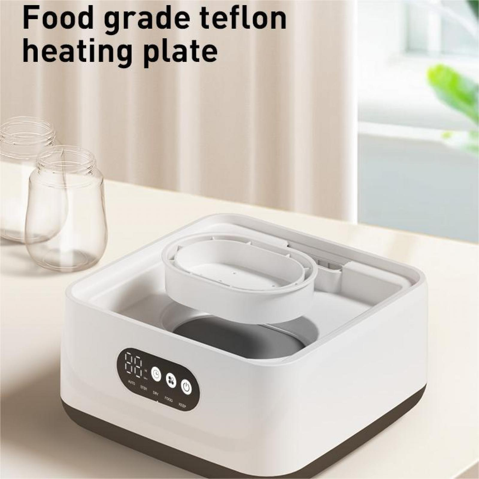 Weiß-schwarze Heizplatte mit einem transparenten Behälter. Das Display zeigt Zahlen. Die Wörter: auto, dry, food und keep sind sichtbar.
