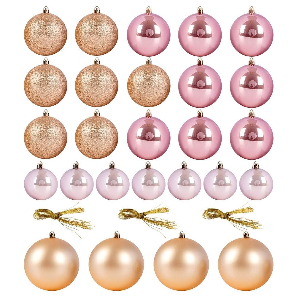 Conjunto de adornos navideños en varios colores: dorado, rosa y blanco. Incluye lazos dorados. Los adornos son redondos y brillantes.