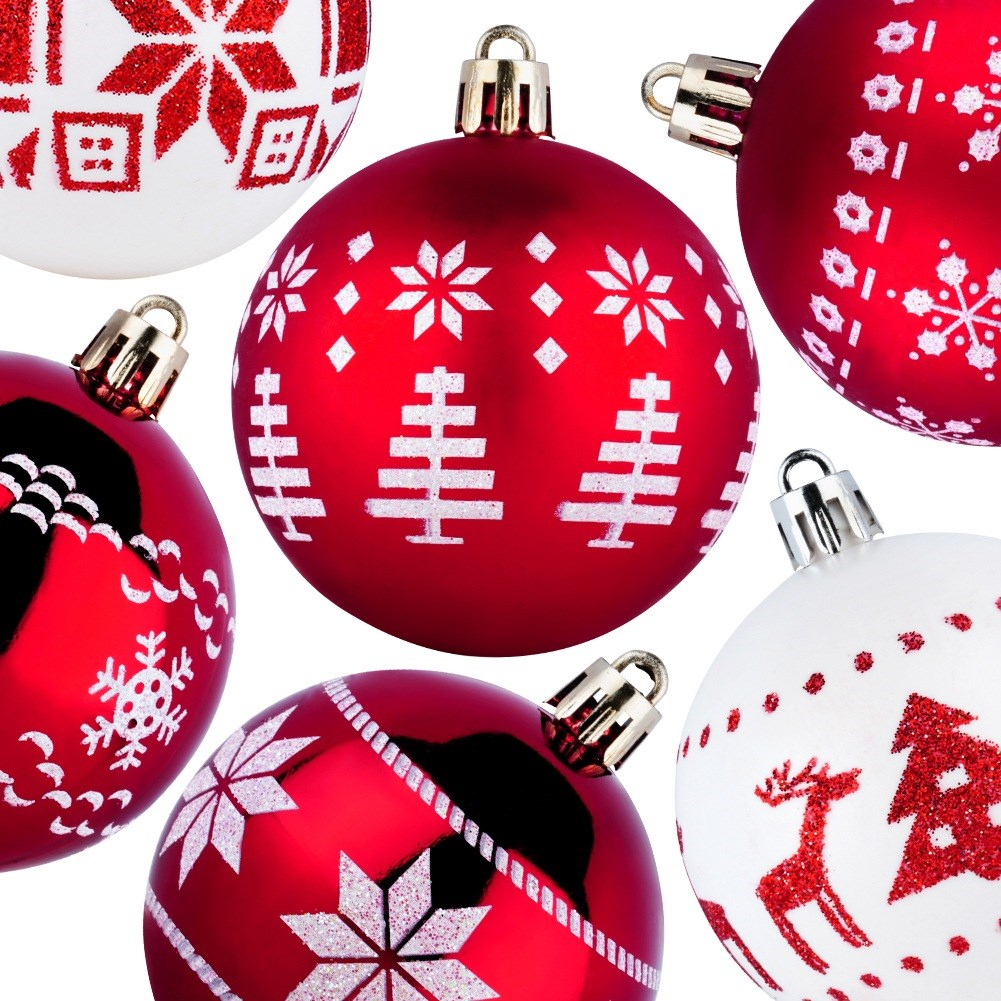 Adornos navideños rojos y blancos con varios diseños, incluyendo copos de nieve y árboles, sobre un fondo blanco.