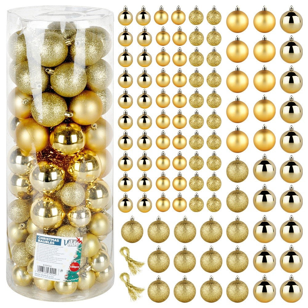 Un tubo transparente lleno de bolas de Navidad doradas. Al lado, varias filas de bolas doradas de diferentes tamaños. Dos borlas doradas.